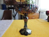 Blue carnival glass compote style candy dish with Roses pattern