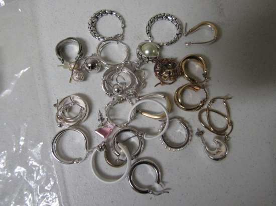 Numerous gold and silver colored earrings
