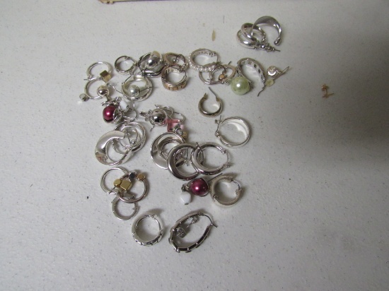 Numerous silver colored earrings