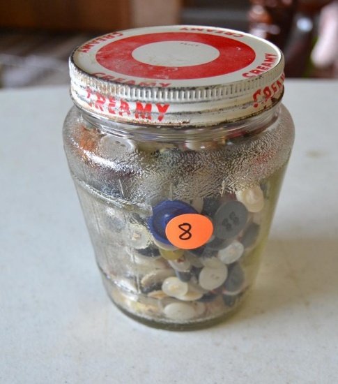 Vintage peanut butter jar full of vintage buttons
