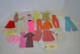 assortment of vintage Barbie clothes