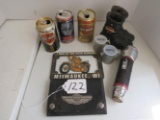 3 beer cans, boots, flashlight, 2 shot glasses, billfold, plate cover, emblem