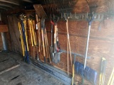 {LOT} A Group of Assorted rakes, pick-axes, hoes, shovels, pitchforks, axes
