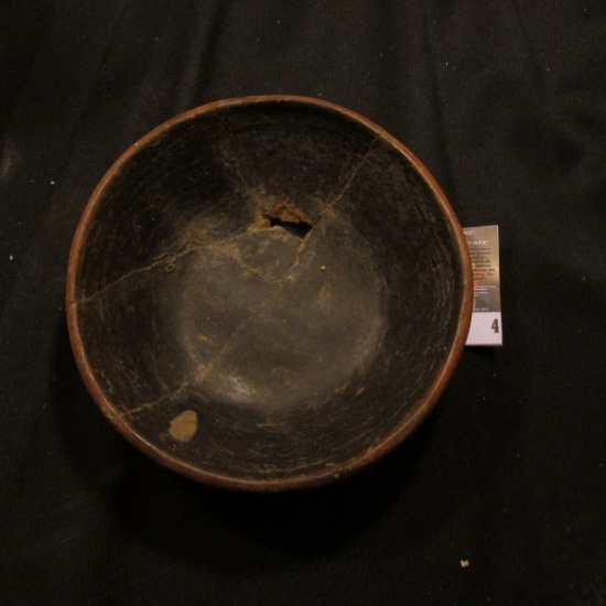 Killed Native American bowl with black interior and red exterior. I am not sure of the provenance or