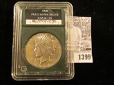 1399 . 1928 P U.S. Peace Silver in a slabbed holder from 