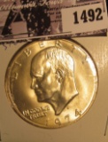 1492 . 1974 S Silver Gem BU Eisenhower Dollar, carded in 2 x 2 holder.