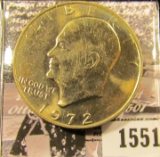 1551 . 1972 P Eisenhower Dollar, Gem BU with light gold toning.