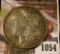 1054 . 1900-O Morgan Silver Dollar, AU toned, reverse has old bulls