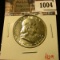 1004 . 1951 Franklin Half Dollar, AU, value $12
