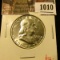 1010 . 1953-D Franklin Half Dollar, AU, value $12