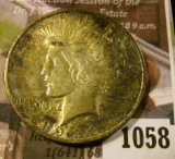 1058 . 1922-D Peace Silver Dollar, AU+, old album toning, value $35