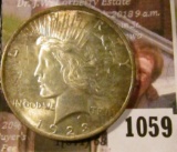 1059 . 1923 Peace Silver Dollar, BU, reverse has light album toning