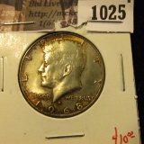1025 . 1968-D Kennedy Half Dollar, UNC toned, value $10