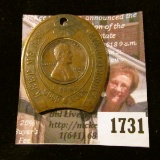 1731 . Encased 1948-D Wheat Cent In A Brass Encasement.  It Says 