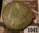 1047 . 1890-O Morgan Silver Dollar, XF/AU, luster with subdued toni