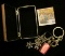 Small Silvered Jewelry Box containing a couple of rings, a Pink faceted Pendant, & a Charm Key Chain