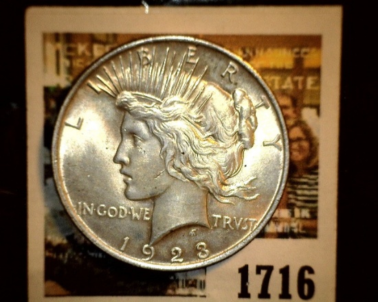 1716 _ 1923 P U.S. Silver Peace Dollar, Choice BU 64. Gold toning.