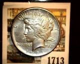 1713 _ 1921 P U.S. Silver Peace Dollar, Choice VF. Small obverse planchet defect. Gold toning.