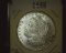 1883 O U.S. Morgan Silver Dollar Semi-prooflike, Gem BU, with light toning areas.