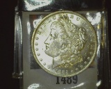 1885 O U.S. Morgan Silver Dollar, Brilliant Uncirculated with scattered toning.