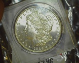 1886 P U.S. Morgan Silver Dollar, Gem Brilliant Uncirculated. In a Snaptight case.