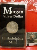 1946.           1878 P Morgan Silver Dollar, 8 tail feathers, Stored in a holder from the Philadelph