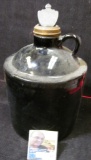 Stoneware base with brass spout; and a pewter bottle top with Eagle design.