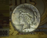 1922 D U.S. Silver Peace Dollar and an old cigar box label 