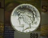 1922 D U.S. Silver Peace Dollar and an old cigar box label 