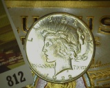 1922 S U.S. Silver Peace Dollar and an old cigar box label 