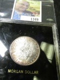 1885 O Morgan Dollar Nice Original Toning, Uncirculated in a 3X3 Capital Holder.