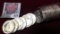 1964 D BU Roll of 90% Silver Kennedy Half Dollars in a plastic tube.
