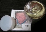 Original BU roll of 1964 D Silver Kennedy Half Dollars in a plastic tube.