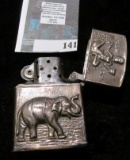 Antique silver lighter with elephant, pagoda, riverboat and female figure, stamped Siam sterling, 49