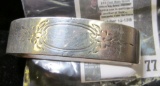 Silver napkin ring, flattened / elongated oval, odd shape, marked STERLING 54x with a winged star ha
