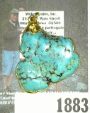 A very attractive Turquoise Nugget encased in a Gold frame.  Ready to be hung from a necklace.