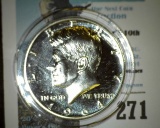 1964 P Proof Kennedy Silver Half-dollar, encapsulated in a removable airtight Cointain.