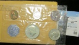 1964 U.S. Proof Set in original cellophane and envelope.  The Cent is heavily toned on the obverse.