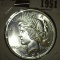 1923 P U.S. Silver Peace Dollar, note on coin was that it was at one certified MS 64.