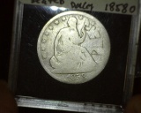 1858 O U.S. Seated Liberty Half Dollar with graffiti scratched on the obverse.