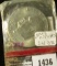 1976-D Eisenhower Dollar, type 1 (1975), still in Mint Cello, BU, value $10+