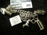 Sterling charm bracelet with 6/charms including beer stein, horse head, convertible car, daschund an