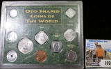 Nine odd-shaped Coins of the World in a hard plastic case. Most BU.