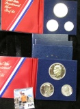 (5) Complete Three-piece 1976 S Silver U.S. Proof Sets in blue holders.