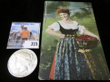 1922 P U.S. Peace Silver Dollar & an early 1900 Postcard of a Lovely Lady Cherry Picker with basket