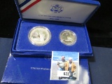 1986 S Statue of Liberty two-piece Set in original box as issued. Silver Dollar & Half-dollar.