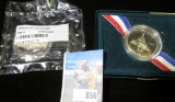 1986 S Statue of Liberty Half Dollar in a Littleton cellopahne; and a 1995 S U.S. Civil War Commemor