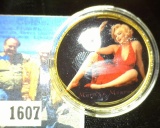 39mm Gold and Enameled Marilyn Monroe Medallion, depicts her both nude and in a red sheer dress.