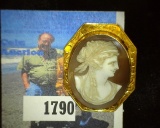 Handcarved Cameo mounted in an engraved 10K Gold framed Bezel.