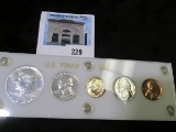 1964 U.S. Proof Set in a white Capital holder.